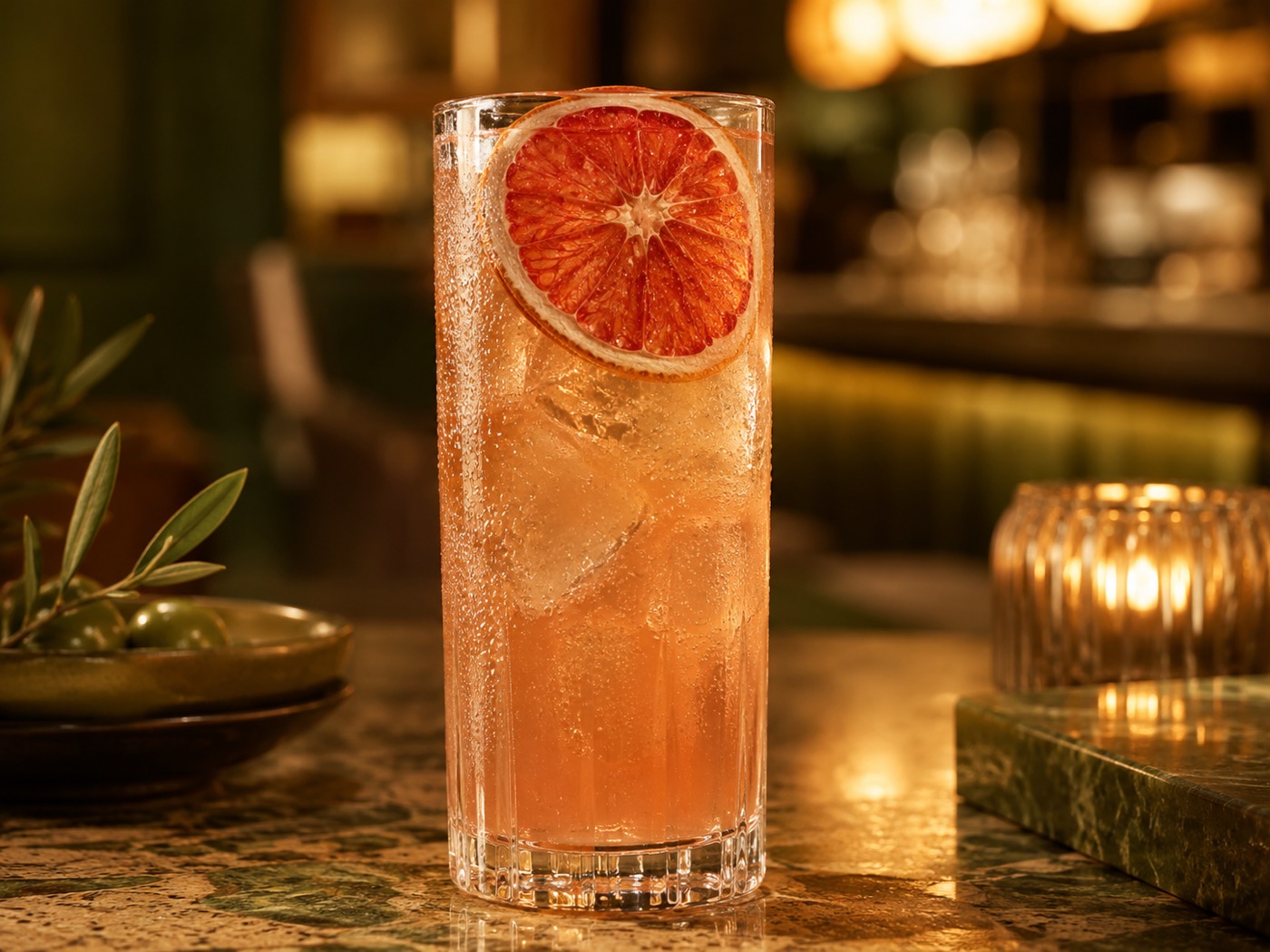 A non-alcoholic mocktail garnished with a dehydrated citrus wheel