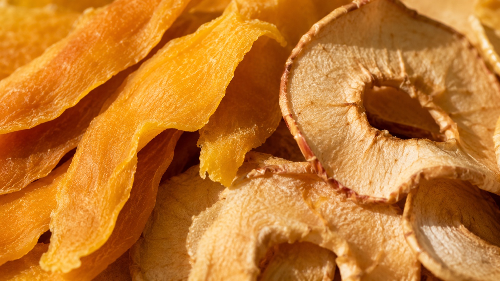 Close-up of dried mango and apple slices showing natural color and texture